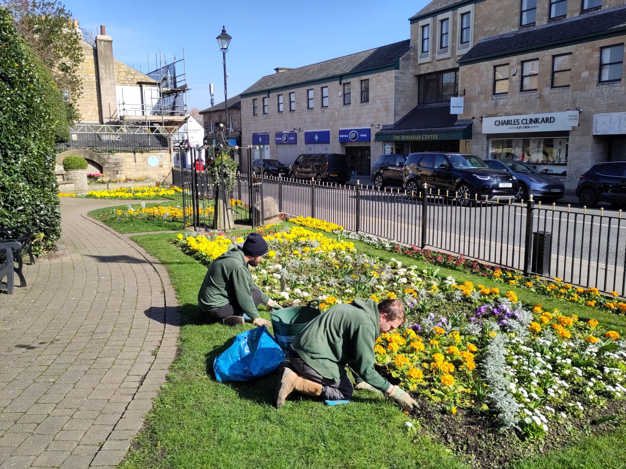 Volunteers maintaining a community flower bed